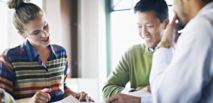 Coworkers discussing project in conference room