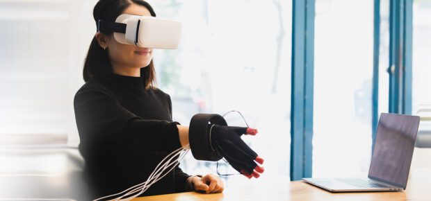 Person interacting with VR glove and VR Headset