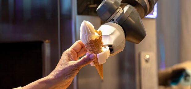 Robot Arm Preparing Ice Cream Cone Serving In The Cafe