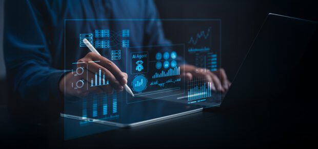 AI Business Analyst Collaborating with Virtual AI Agent to Analyze Big Data in Real Time on a Holographic Dashboard with Computers and Laptops in a Dark Blue-Lit Room
